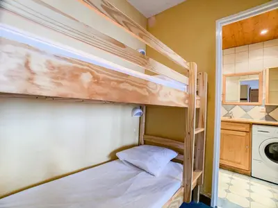 Un ou plusieurs lits dans un hébergement de l'établissement Appartement confort près des pistes et commerces avec balcon, animaux acceptés - FR-1-502-501