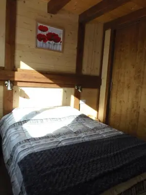 Un ou plusieurs lits dans un hébergement de l'établissement Chalet l'aubépine résidence B&B