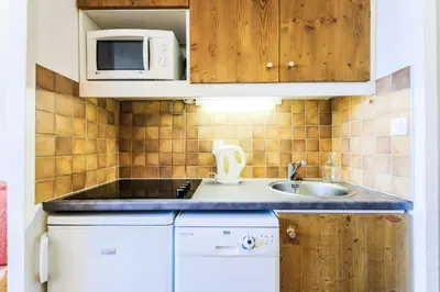 Cuisine ou kitchenette dans l'établissement Résidence Les Constellations - maeva Home - Studio 4 personnes Confort MAE-5086