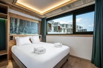 Un ou plusieurs lits dans un hébergement de l'établissement Chalet Hôtel Quartz