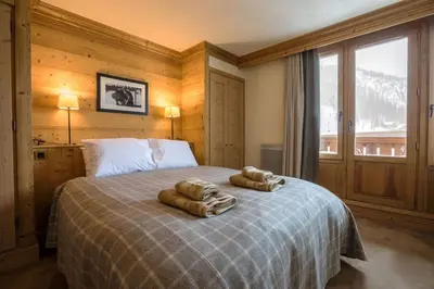 Un ou plusieurs lits dans un hébergement de l'établissement L'Aquila 34 - 3-bedroom ski-in ski-out apartment
