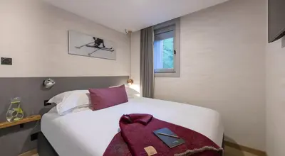 Un ou plusieurs lits dans un hébergement de l'établissement Luxueux duplex accès direct aux pistes avec piscine privée