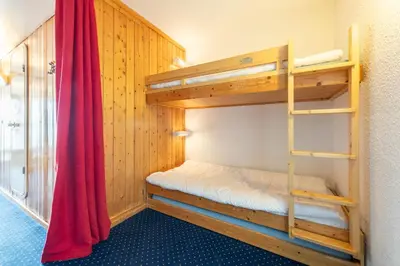 Un ou plusieurs lits dans un hébergement de l'établissement Appartement ambiance cosy Les ARCS 1800