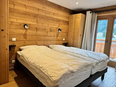 Un ou plusieurs lits dans un hébergement de l'établissement Appartement cosy au pied des pistes avec parking privatif - FR-1-464-242
