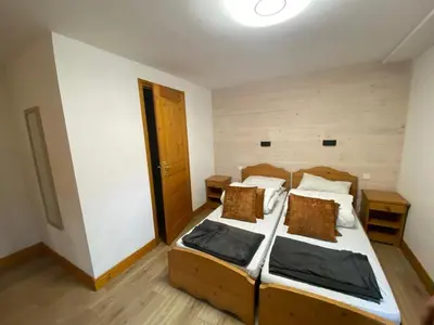 Un ou plusieurs lits dans un hébergement de l'établissement Chalet Marmotton-Domaine des Arcs