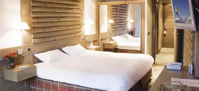 Un ou plusieurs lits dans un hébergement de l'établissement Hotel Le Ski D'or