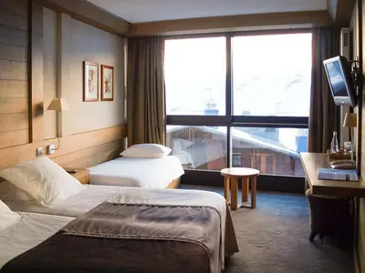 Un ou plusieurs lits dans un hébergement de l'établissement Hotel Le Ski D'or