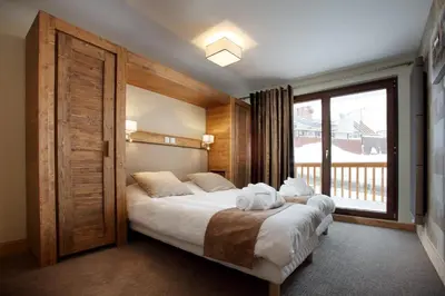Un ou plusieurs lits dans un hébergement de l'établissement Chalet des Neiges -La Source des Arcs