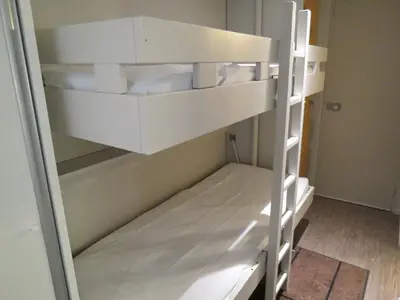 Un ou plusieurs lits dans un hébergement de l'établissement Appart 8 Personnes avec Salon Neuf et Parking Couvert Le Thuria