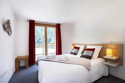 Un ou plusieurs lits dans un hébergement de l'établissement Madame Vacances Chalet Ponturin