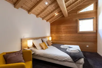 Un ou plusieurs lits dans un hébergement de l'établissement Madame Vacances Chalet Ponturin