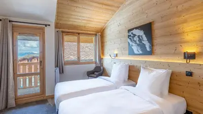 Un ou plusieurs lits dans un hébergement de l'établissement Spacieux appt BELLE PLAGNE 6-8 pers SAUNA