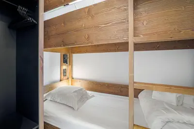 Un ou plusieurs lits dans un hébergement de l'établissement Appartement Le Névé - Vue lac