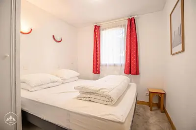Un ou plusieurs lits dans un hébergement de l'établissement Résidence Les Flocons D'argent - Appartement douillet et confortable au pied des pistes MAE-1093