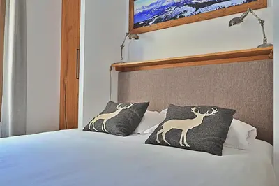 Un ou plusieurs lits dans un hébergement de l'établissement Tome, superbe appartement avec terrasse vue montagne