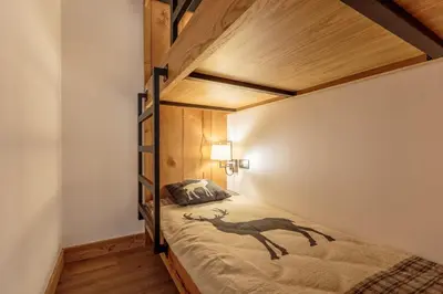 Un ou plusieurs lits dans un hébergement de l'établissement Tome, superbe appartement avec terrasse vue montagne