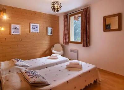Un ou plusieurs lits dans un hébergement de l'établissement Chalet Les Mélèzes Sud