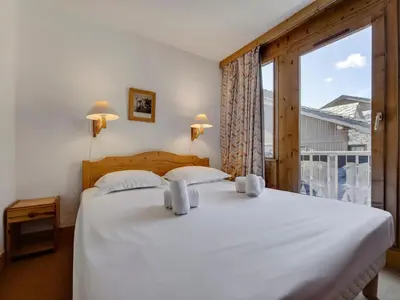 Un ou plusieurs lits dans un hébergement de l'établissement Duplex Confortable Ski aux Pieds avec Parking - FR-1-862-55