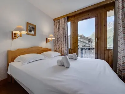 Un ou plusieurs lits dans un hébergement de l'établissement Duplex Confortable Ski aux Pieds avec Parking - FR-1-862-55