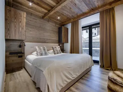 Un ou plusieurs lits dans un hébergement de l'établissement Appartement rénové 4 chambres ski aux pieds avec parking à Val-d'Isère - FR-1-862-9