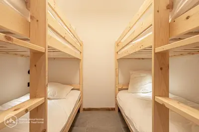 Un ou plusieurs lits dans un hébergement de l'établissement Marmotte RDJ01 - Appartement neuf en face du télésiège