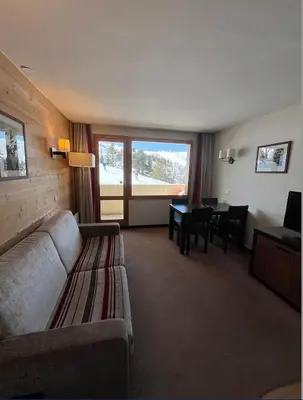 Coin salon dans l'établissement Belle Plagne Le QUARTZ Ski aux pieds
