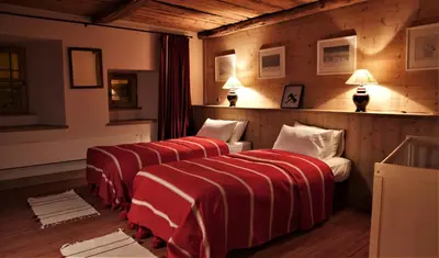Un ou plusieurs lits dans un hébergement de l'établissement Chalet Geneviève