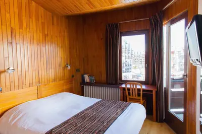 Un ou plusieurs lits dans un hébergement de l'établissement Hôtel La Vanoise