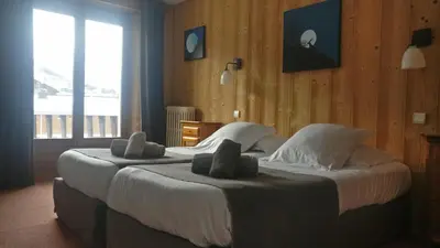 Un ou plusieurs lits dans un hébergement de l'établissement Hôtel Bellier