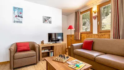 Télévision ou salle de divertissement dans l'établissement Madame Vacances Résidence Les Jardins de la Vanoise