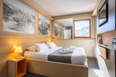 Un ou plusieurs lits dans un hébergement de l'établissement Hôtel Club MMV Les Brévières