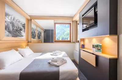 Un ou plusieurs lits dans un hébergement de l'établissement Hôtel Club MMV Les Brévières