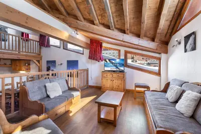 Coin salon dans l'établissement Les Suites du Val Claret by ExplorHome