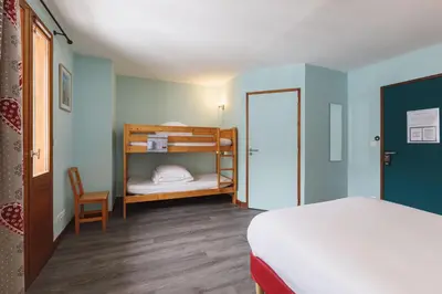 Un ou plusieurs lits dans un hébergement de l'établissement Hotel Chalet du Bon Air