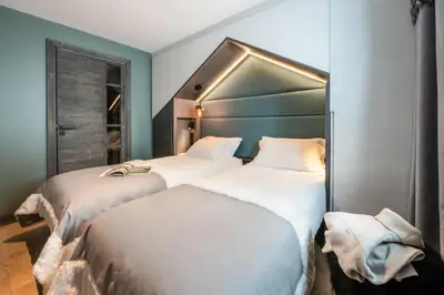 Un ou plusieurs lits dans un hébergement de l'établissement Chalets Izia - Village Montana