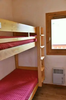 Un ou plusieurs lits dans un hébergement de l'établissement Chalet Le Grand Cap