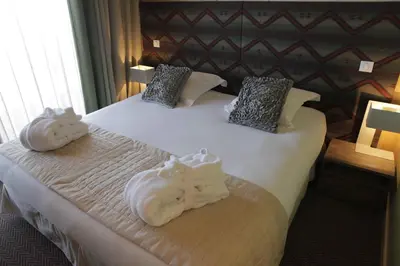 Un ou plusieurs lits dans un hébergement de l'établissement L'Aiguille Grive Chalets Hotel