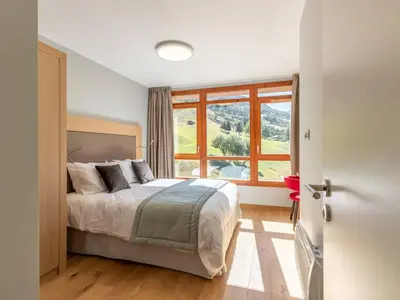 Un ou plusieurs lits dans un hébergement de l'établissement Duplex 4 chambres avec piscine, spa et parking aux Arcs 1800 - FR-1-352-55
