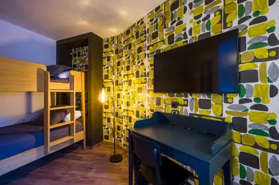 Télévision ou salle de divertissement dans l'établissement L'Outa Hotel Restaurant