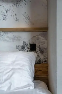 Un ou plusieurs lits dans un hébergement de l'établissement Chalet Eden Roc