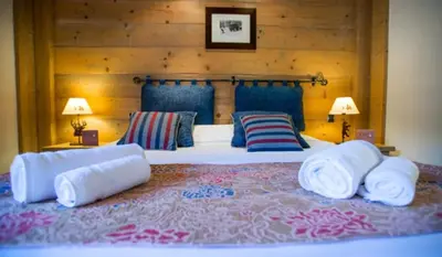 Un ou plusieurs lits dans un hébergement de l'établissement Chalet Hotel L’Ecrin