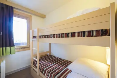 Un ou plusieurs lits dans un hébergement de l'établissement Residence Les Gemeaux - maeva Home