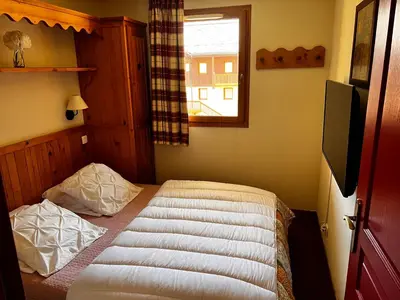 Un ou plusieurs lits dans un hébergement de l'établissement Les Alpages location appartement 202
