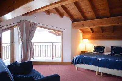 Un ou plusieurs lits dans un hébergement de l'établissement Goélia Les Chalets des Deux Domaines