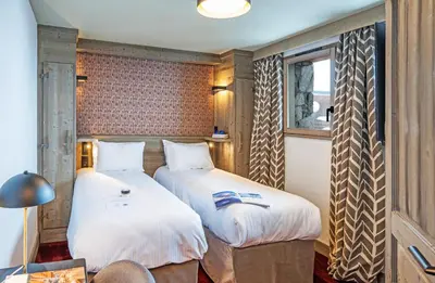 Un ou plusieurs lits dans un hébergement de l'établissement Hôtel L'Aigle du Montana by Les Etincelles