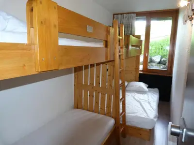 Un ou plusieurs lits dans un hébergement de l'établissement Résidence Tournavelles - Bel appartement 4 pièces pour 8/10 personnes en duplex, avec vue sur les pistes, skis aux pieds et proche des commerces dans le MAE-1864