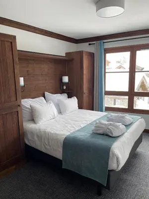 Un ou plusieurs lits dans un hébergement de l'établissement Appartement Arc 1950 - Manoir de Savoie