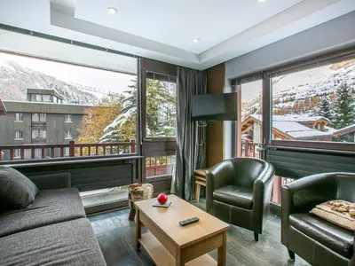 Coin salon dans l'établissement Appartement élégant et rénové, idéalement situé sur le front de neige à Val d'Isère, proche du village - FR-1-694-262